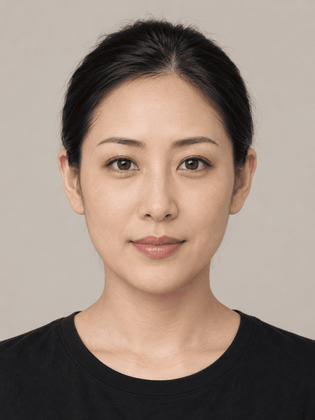 Woman, front view, with light warm-toned skin and straight black hair pulled back in a low bun.