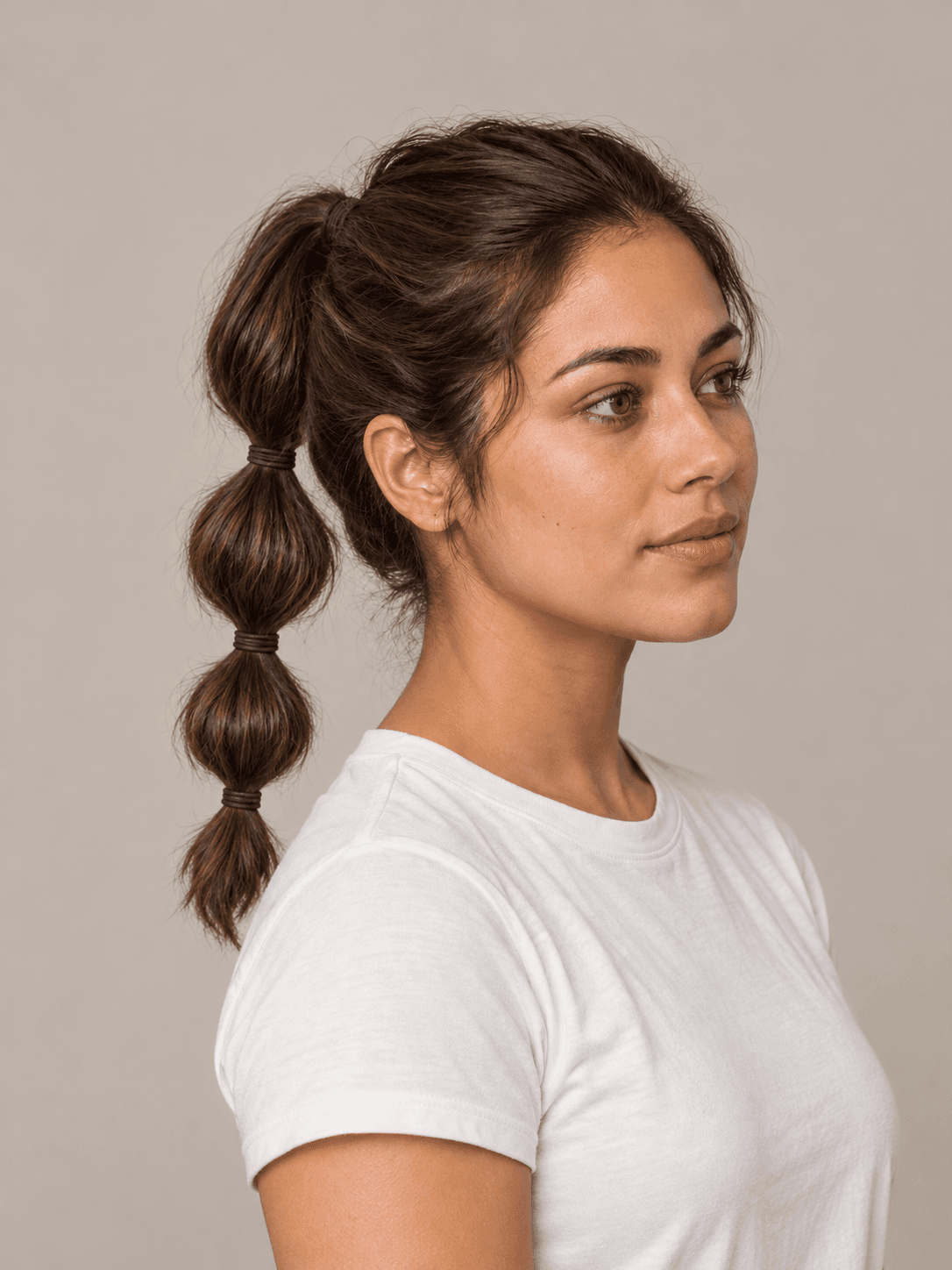 Bubble Ponytail on a woman with light olive skin and brown hair, three-quarter view
