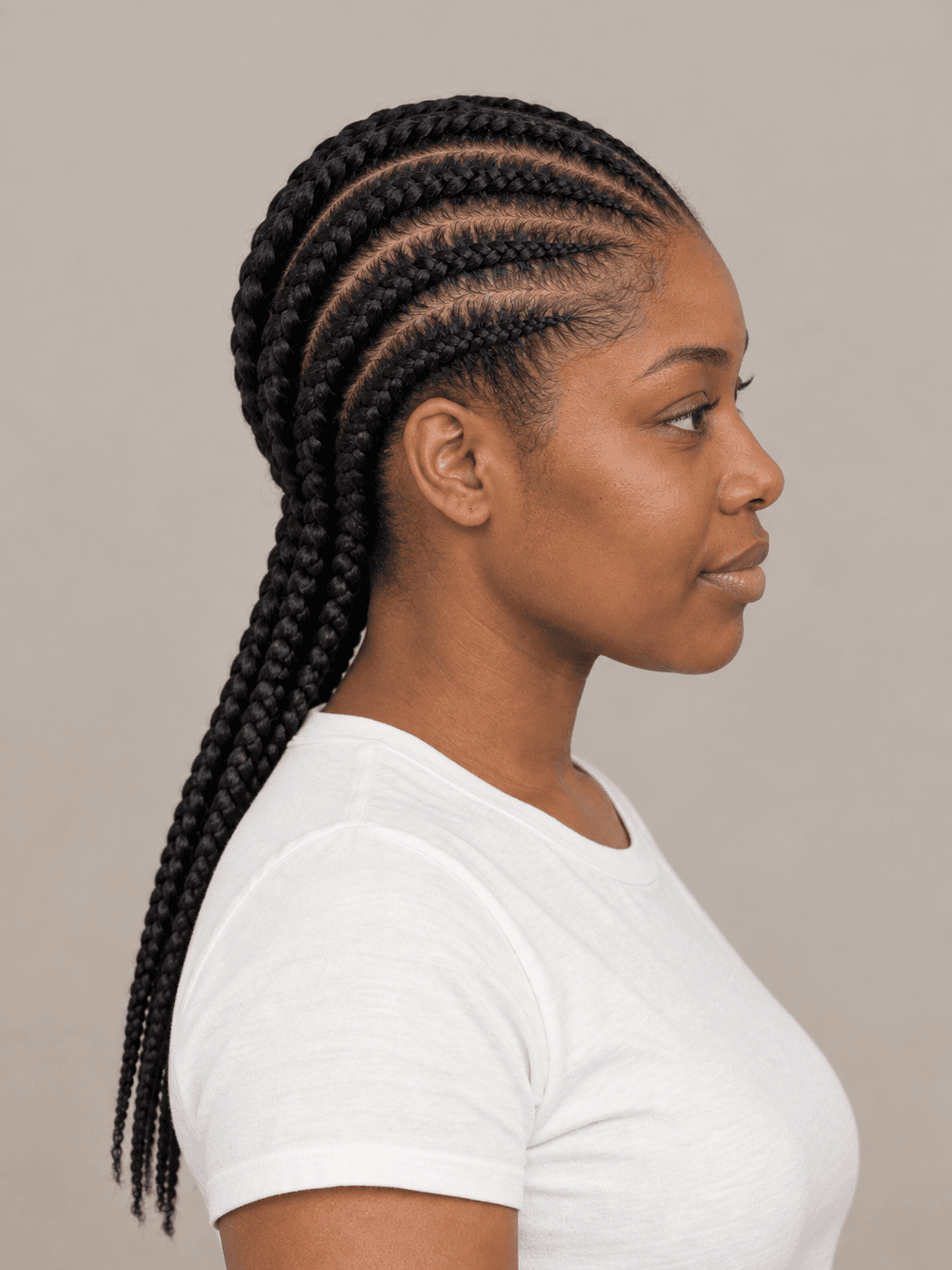 Feed-in Cornrows on a woman with dark brown skin and black hair, side view