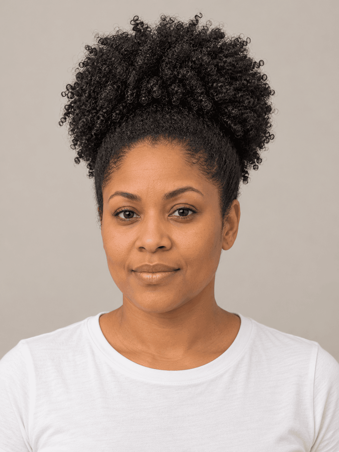 High puff on a woman with medium brown skin and coily hair, front view