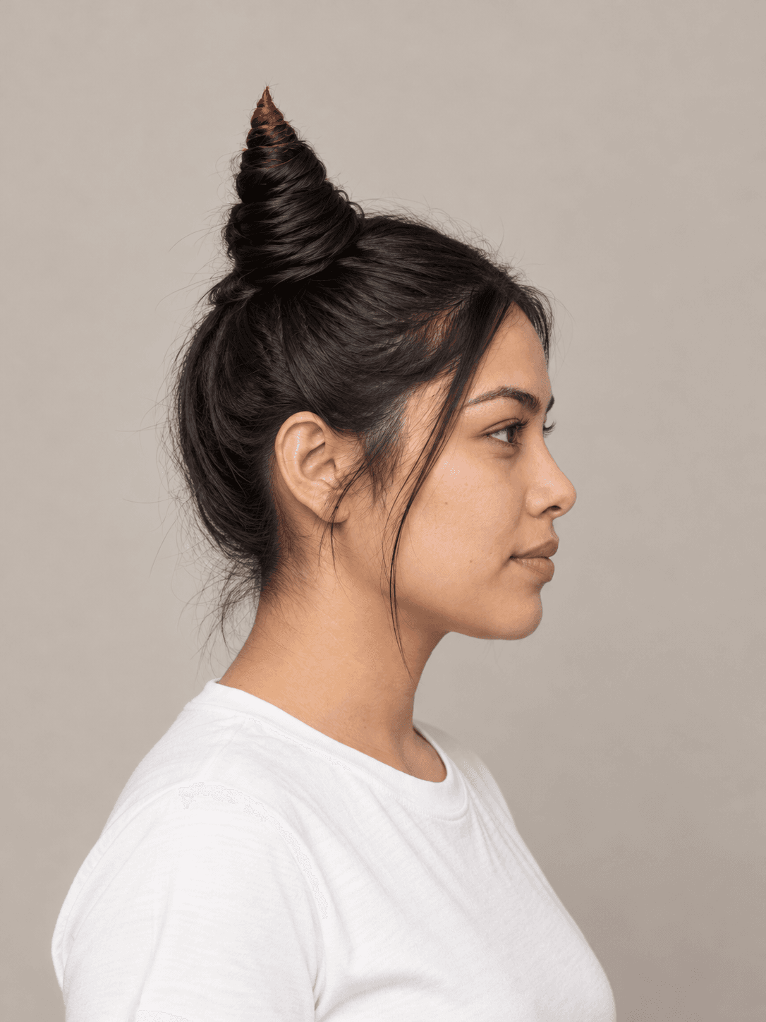 Horn Buns on a woman with light tan skin and black hair, side view