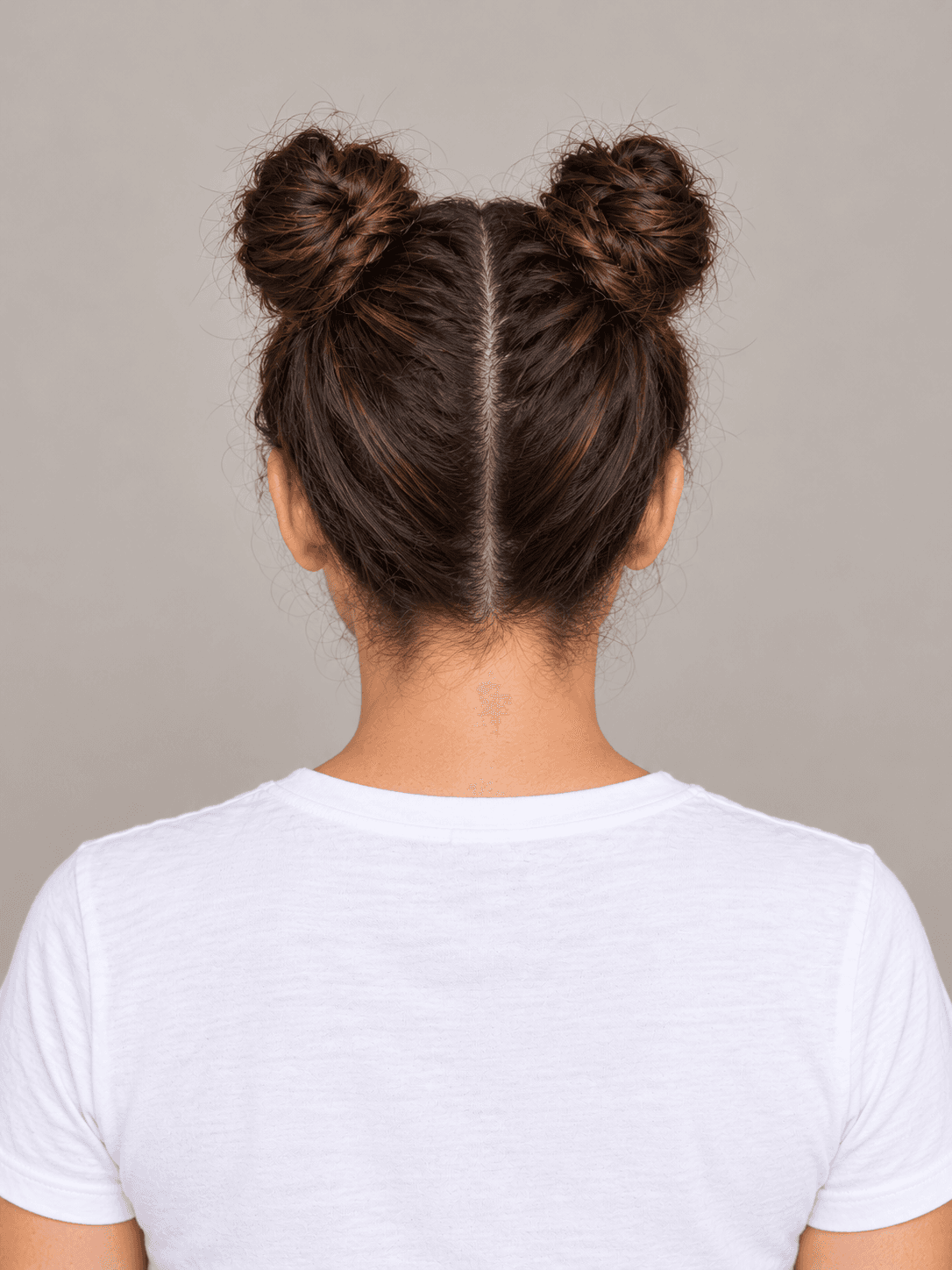Space Buns with Glitter Roots on a woman with light olive skin and dark brown hair, back view