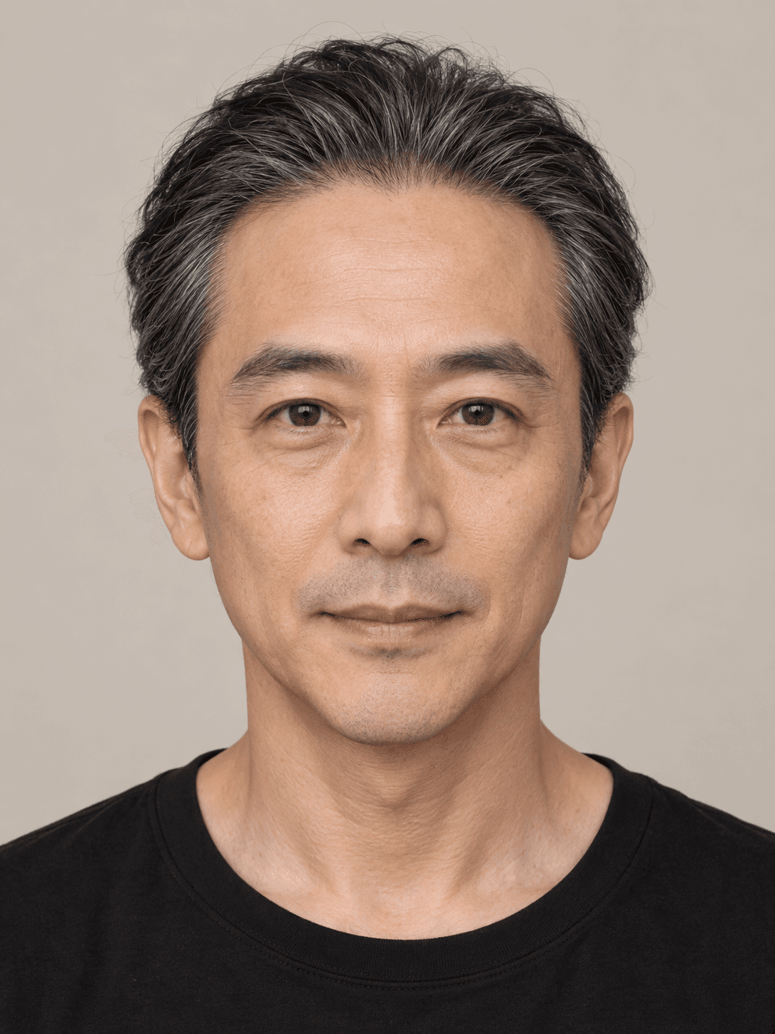 Man, front view, with light medium-toned skin and straight black hair with grey, brushed straight back.
