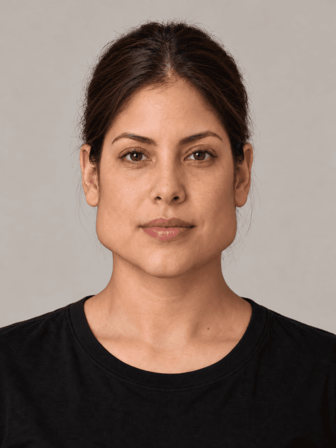 Woman, front view, with medium warm-toned skin and straight brown hair pulled back in a low bun.